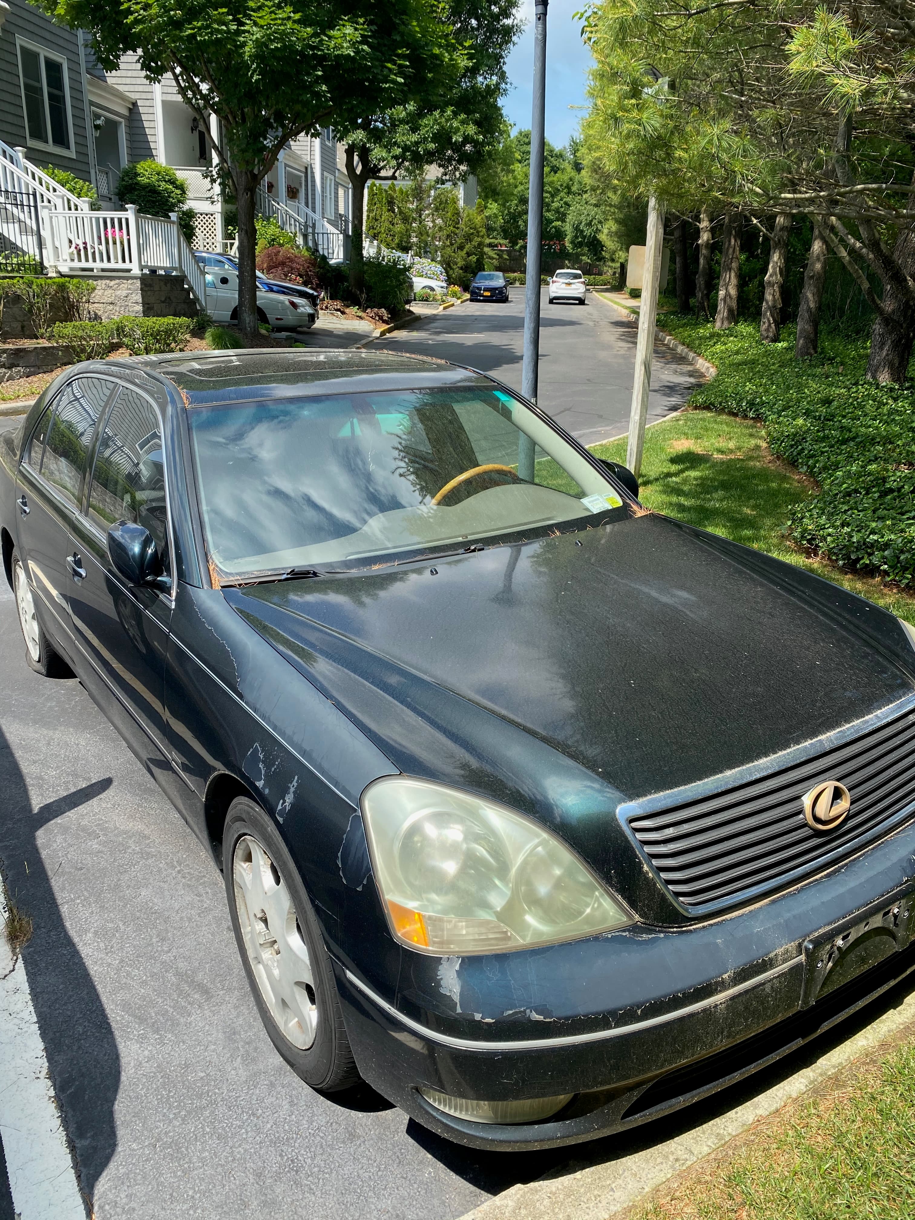 Dark green Lexus LS 430 sedan parked on a residential street on a sunny day